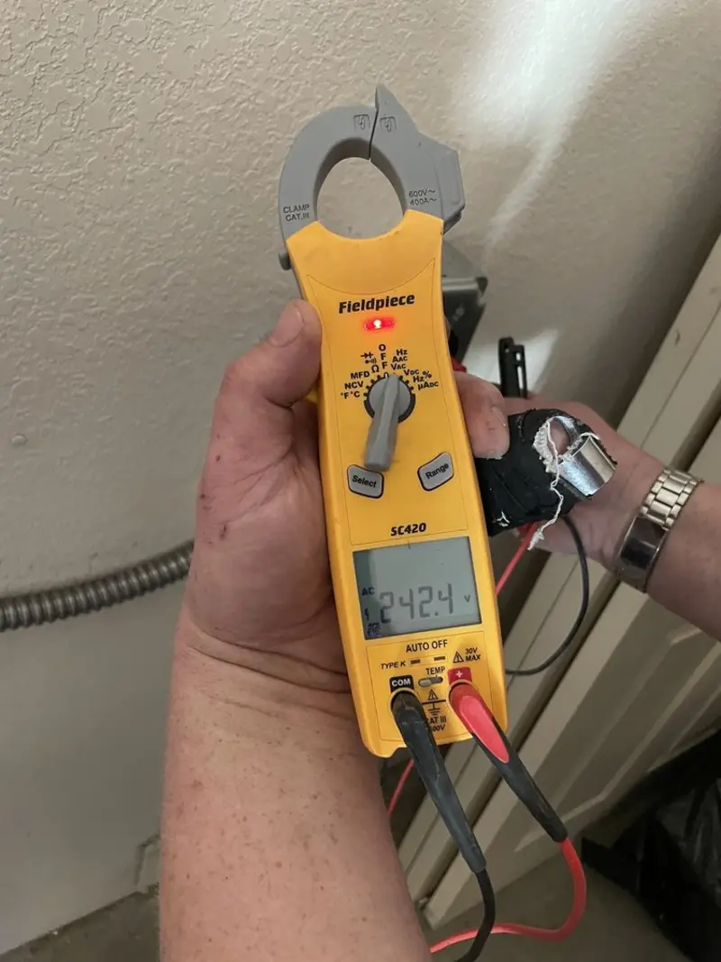 Voltage testing with clamp meter during Electrical Installation Services in Colona